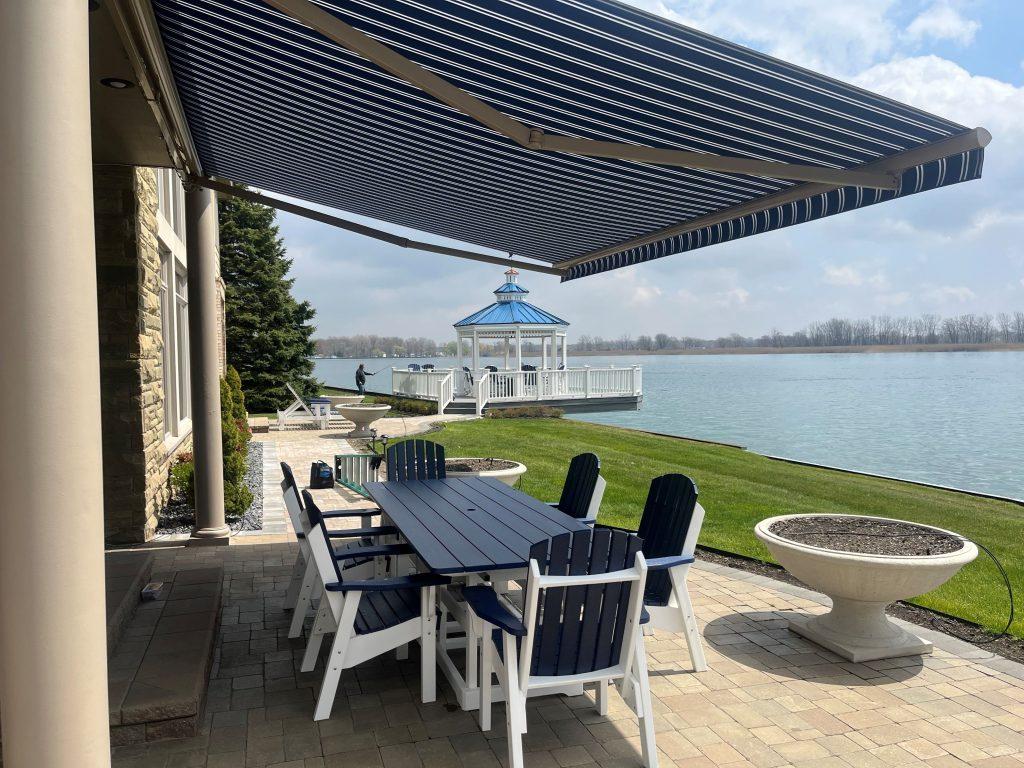 A vibrant blue retractable awning on a waterside home.
